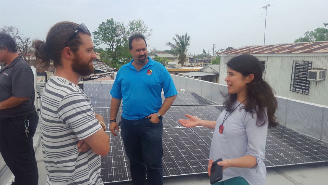 Resilient Power PR co-founder Cristina Roig-Morris in San Juan, working with a team installing solar panels over a community center.  