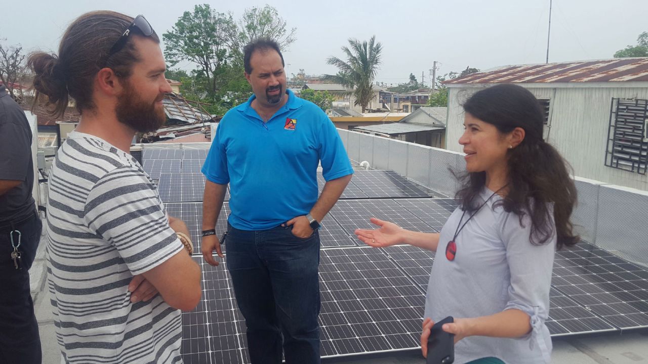 Resilient Power PR co-founder Cristina Roig-Morris in San Juan, working with a team installing solar panels over a community center.  