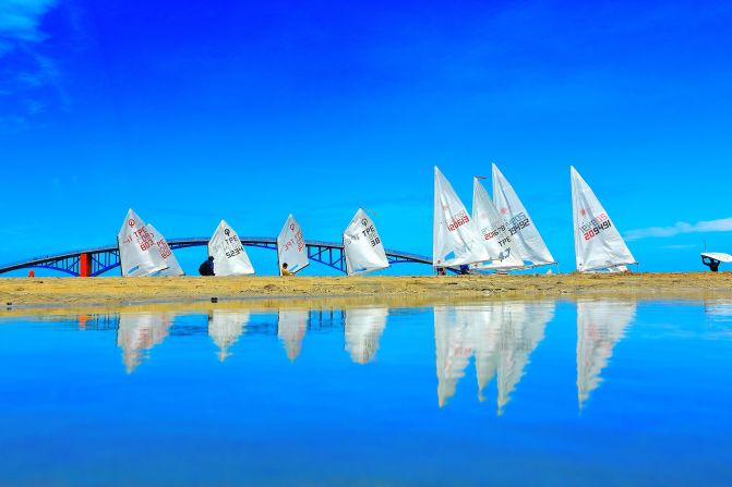 During the Taiwan Regatta on Penghu Island, Lien Shou Lin photographed sails and their reflections, as the boats gathered at the starting line.