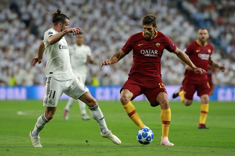 Federico Fazio of AS Roma is challenged by Gareth Bale who helped Real Madrid to a 3-0 win with the second goal in the Santiago Bernabeu.