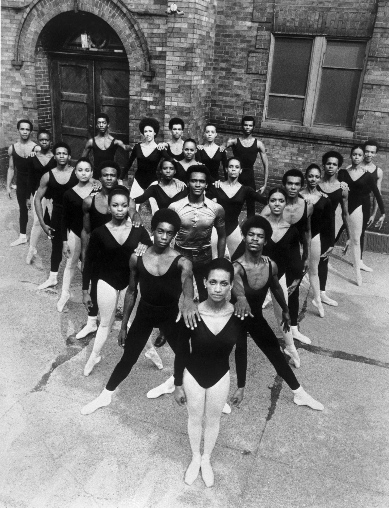 Mitchell stands in the middle of dancers of the Black Ballet Company in 1973. Revered for his artistic accomplishments, Mitchell was driven by the belief that dance can effect social change. 