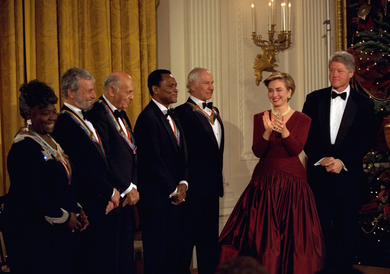 President Bill Clinton and first lady Hillary Clinton applaud the recipients of the 1993 Kennedy Center Honors, including Mitchell, in the East Room of the White House.