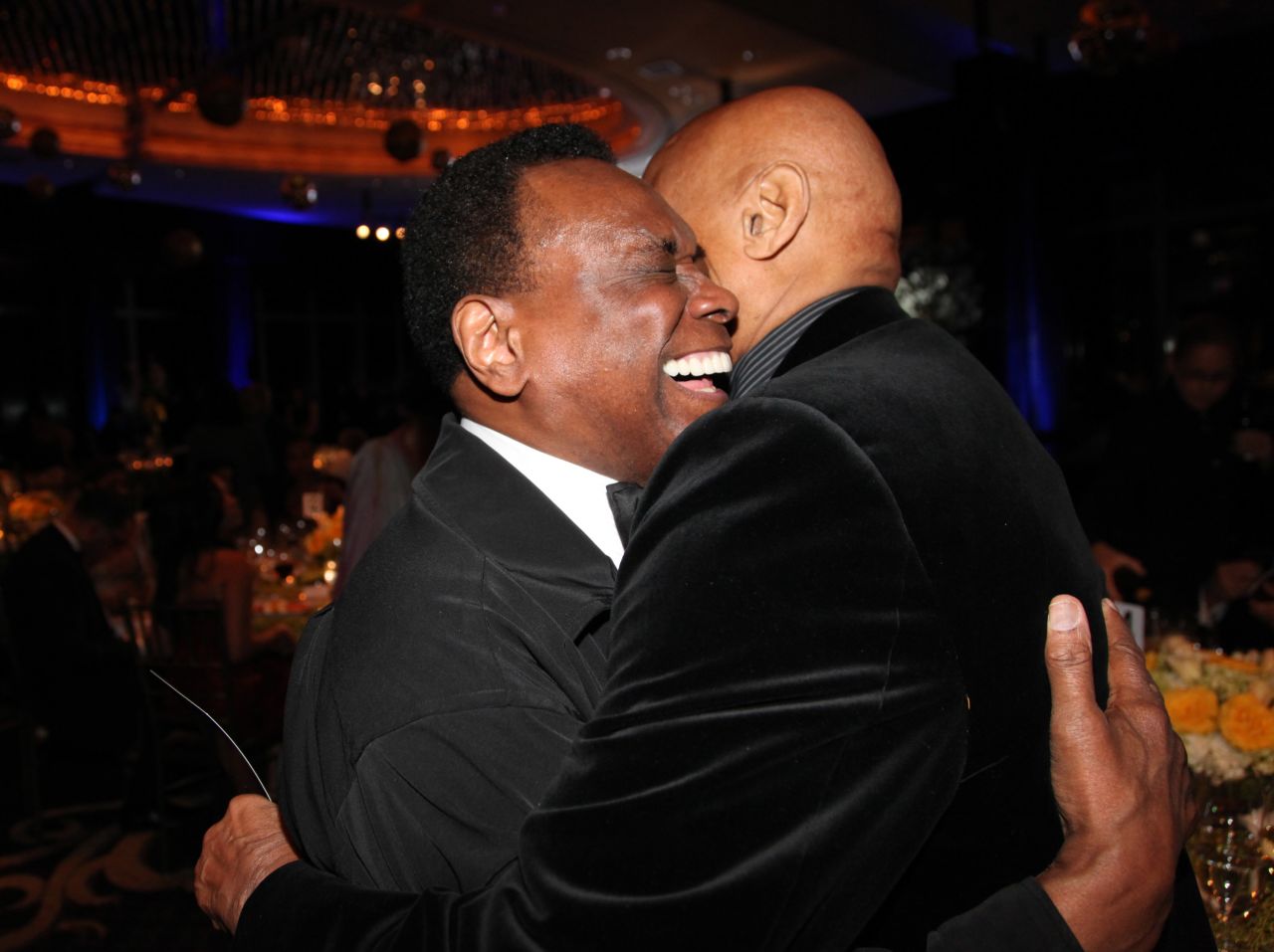 Mitchell and singer Harry Belafonte hug at a Dance Theatre of Harlem gala in 2012.