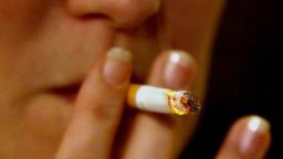 LONDON, UNITED KINGDOM:  A woman smokes a cigarette in a pub in London 16 November, 2004.  Britain unveiled tough plans Tuesday to ban smoking in all workplaces and restaurants, as well as most pubs and bars, as part of a major push to improve the health of the nation. Within the next four years, smoking will be outlawed at every workplace and restaurant, and around 90 percent of pubs and bars which prepare and serve food, in England.          AFP PHOTO/NICOLAS ASFOURI  (Photo credit should read NICOLAS ASFOURI/AFP/Getty Images)