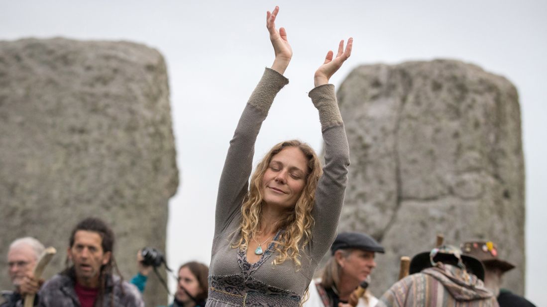 <strong>Wiltshire, England:</strong>  A woman dances as druids, pagans and revelers gather at Stonehenge for the sunrise.