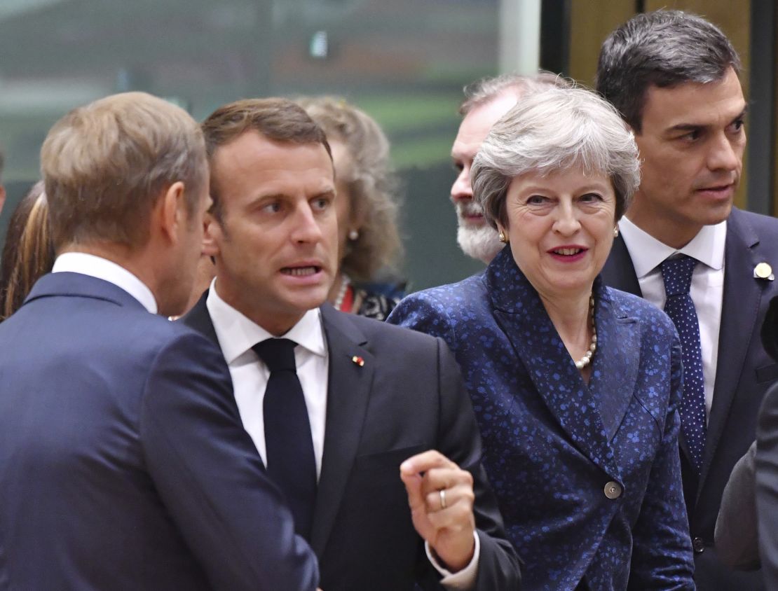 French President Emmanuel Macron, second left, speaks with European Council President Donald Tusk, left, as Spanish Prime Minister Pedro Sanchez, right, and British Prime Minister Theresa May, enter the room.
