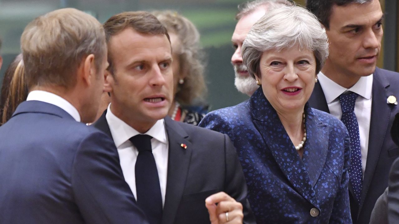 French President Emmanuel Macron, second left, speaks with European Council President Donald Tusk, left, as Spanish Prime Minister Pedro Sanchez, right, and British Prime Minister Theresa May, enter the room.
