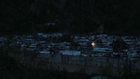 Car lights are seen in a powerless neighborhood of Utuado, three weeks after the hurricane.