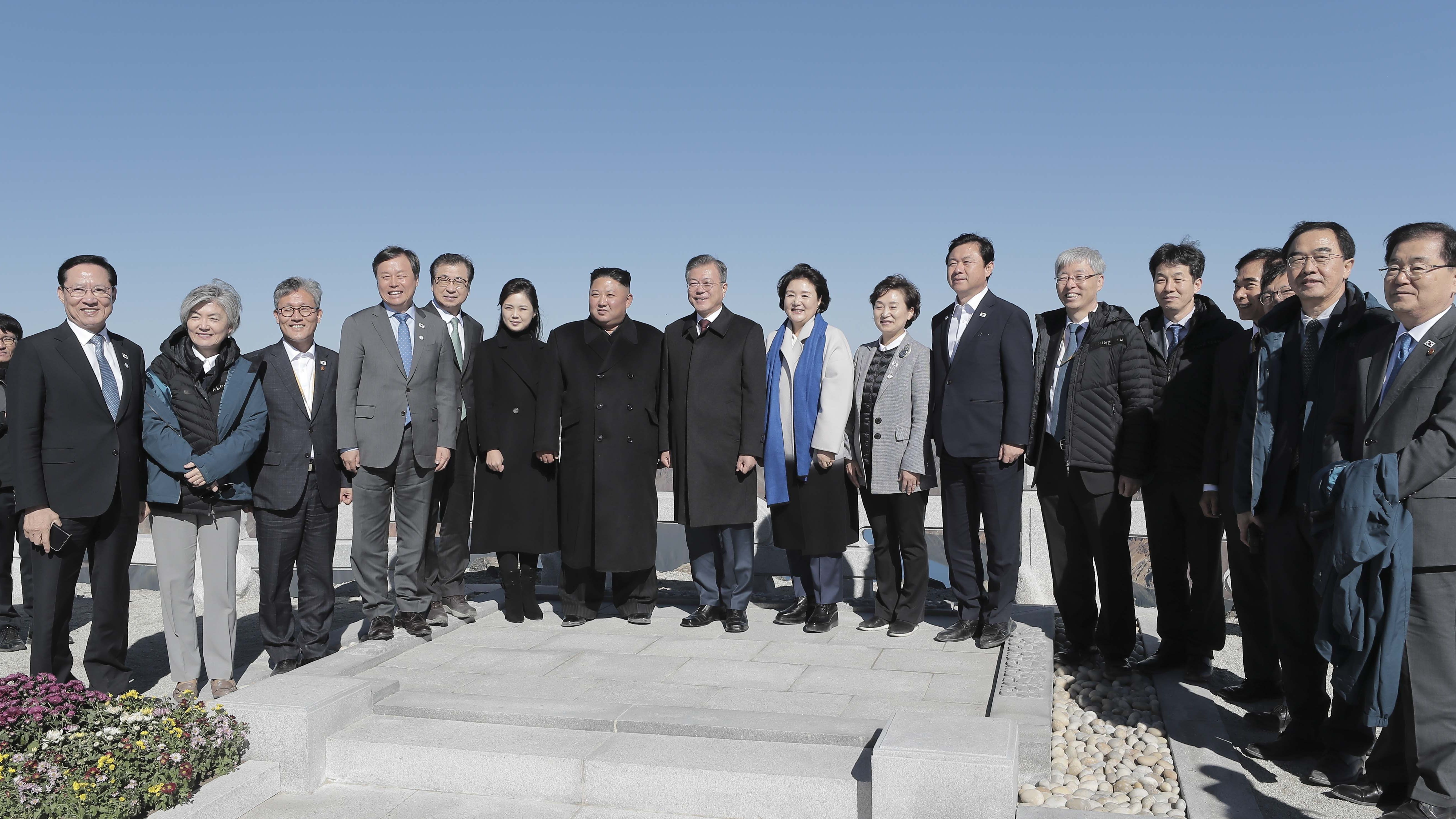 Moon, Kim and officials from both Koreas pose for a picture atop the mountain.