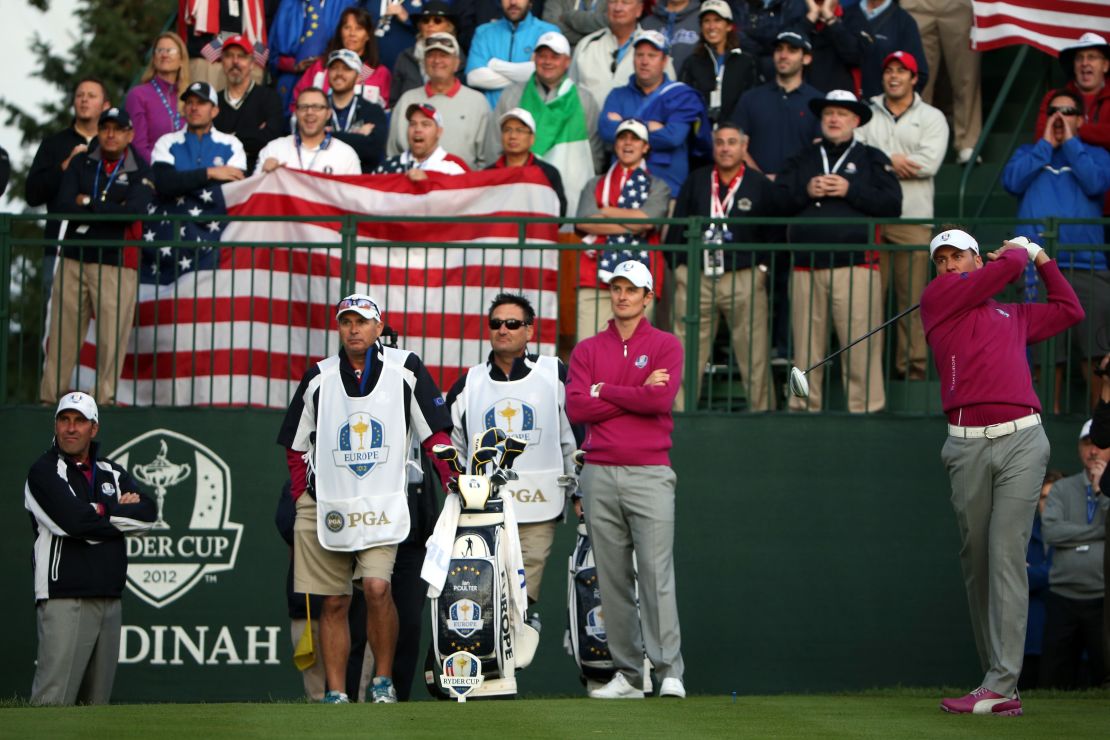 Poulter (right) tees off as the crowd roars at Medinah in 2012.
