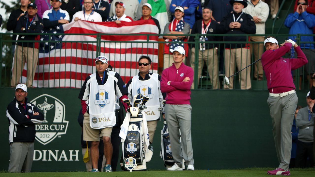 Poulter (right) tees off as the crowd roars at Medinah in 2012.