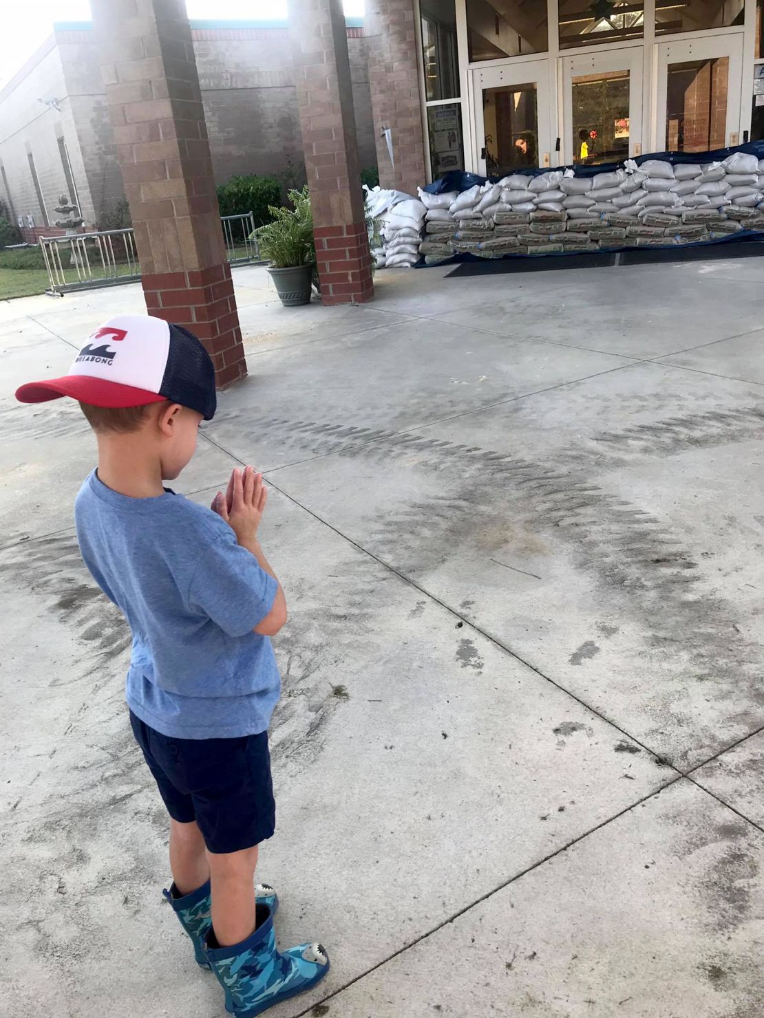 Brad Whiteis took a photo of his son Carter, 5, praying in front of his school in Conway, South Carolina, as the area still faces threat of flooding.