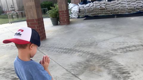 Brad Whiteis took a photo of his son Carter, 5, praying in front of his school in Conway, South Carolina, as the area still faces threat of flooding.