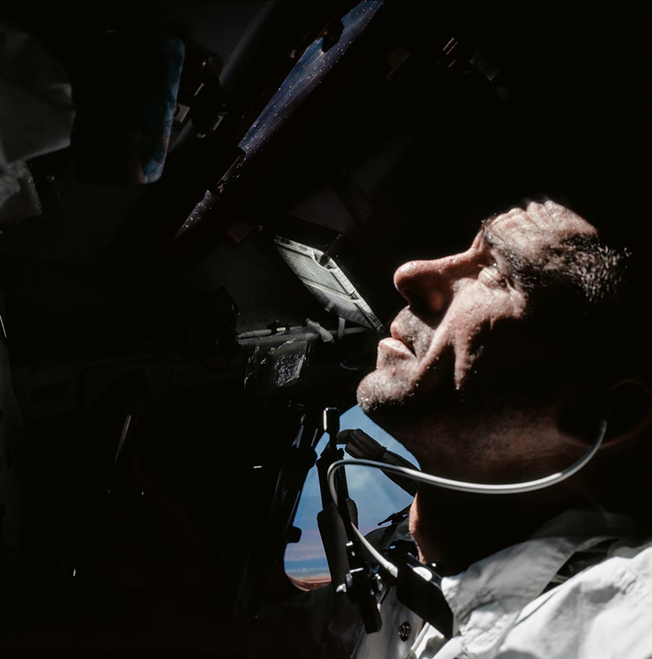 Astronaut Walt Cunningham looks out of the Command Module window during Apollo 7's 11-day orbit around the Earth. 