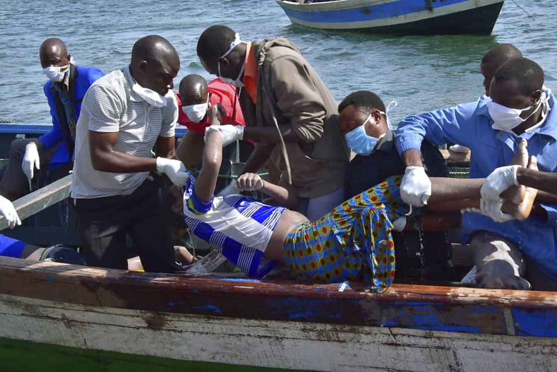Rescuers retrieve a body from the water Friday near Ukara Island on Lake Victoria.