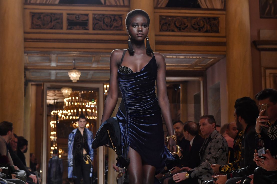 Adut Akech walks the runway at the Versace Autumn-Winter 2018 show in Milan.