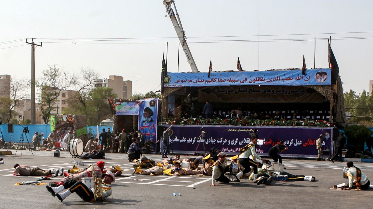 Injured soldiers lie on the ground after Saturday's attack on a military parade Ahvaz, Iran.