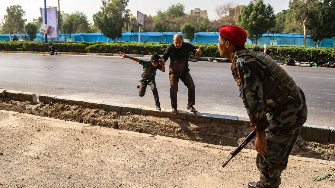 A man and a boy run to escape from the barage of gunfire in Ahvaz.