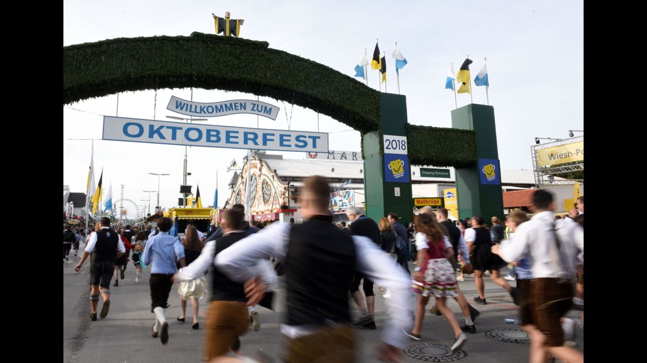 Visitors arrive for the opening of the 185th Oktoberfest in Munich, Germany, on Saturday, September 22. The world's largest beer festival continues through October 7.