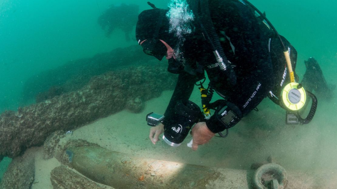 Maritime archaeologists explore the shipwreck.