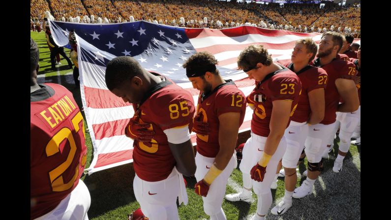 After a pregame moment of silence to honor Celia Barquin Arozamena, members of the Iowa State Cyclones bow their heads during the National Anthem on Saturday, September 22, in Ames, Iowa. Barquin Arozamena, an accomplished student-athlete at Iowa State, was found dead September 17 after she was assaulted, officials said.