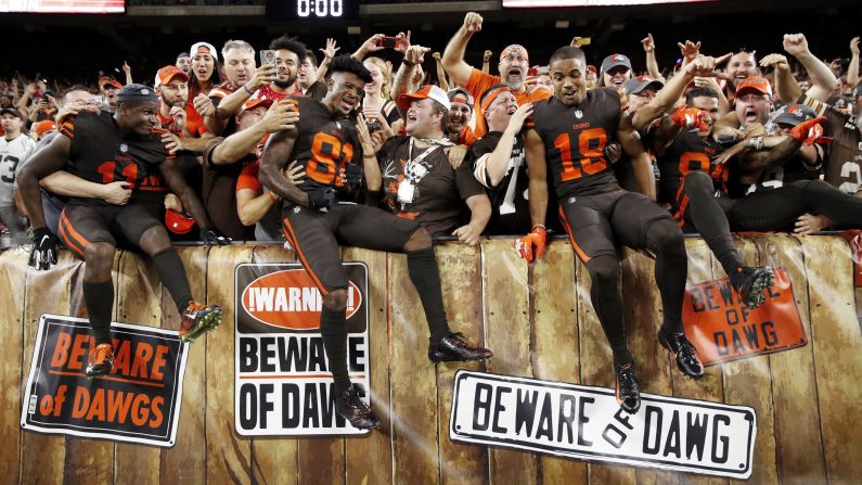 Cleveland Browns players celebrate with fans after winning the game against the New York Jets on Thursday, September 20, in Cleveland. The Browns won 21-17.