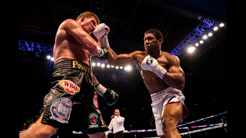 Anthony Joshua and Alexander Povetkin trade punches during the IBF, WBA Super, WBO & IBO World Heavyweight Championship title fight on Saturday, September 22, in London.
