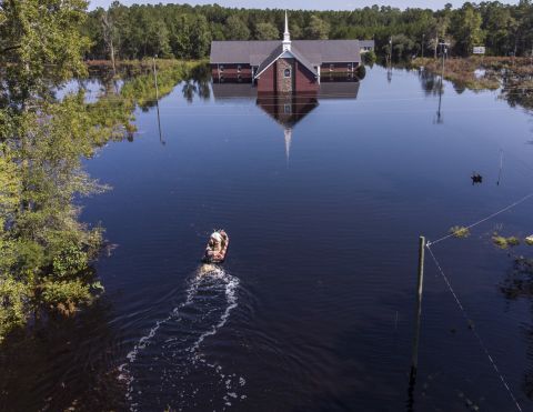 Avery Singleton takes a boat to Pine Grove Baptist Church in Brittons Neck, South Carolina, on Saturday.