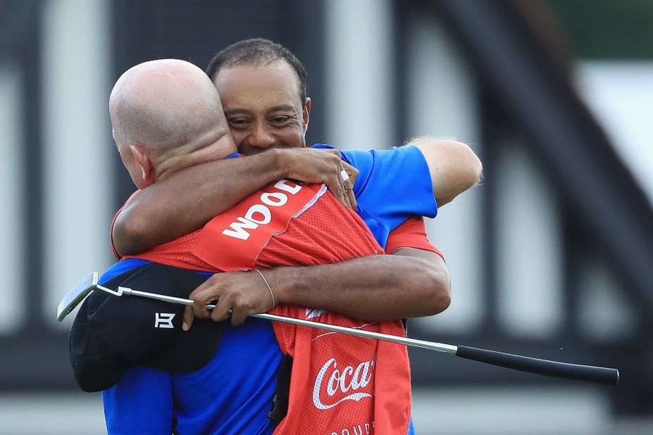 Woods hugs caddie Joe LaCava after winning. Woods has been plagued by pain and injury problems in recent years.