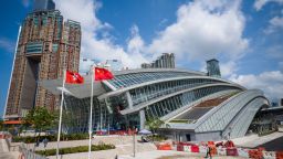 The flags of Hong Kong (L) and China are seen hoisted outside the West Kowloon train station of the High Speed Rail Link to Guangzhou as sales counters were opened to the public for the first time in Hong Kong on September 10, 2018. - Tickets went on sale ahead of the first journeys on September 23 for the the high-speed connection out of the harbour-front West Kowloon station, which will link Hong Kong to the southern Chinese city of Guangzhou 80 miles (130km) away and then onto China's national rail network. (Photo by ANTHONY WALLACE / AFP)        (Photo credit should read ANTHONY WALLACE/AFP/Getty Images)