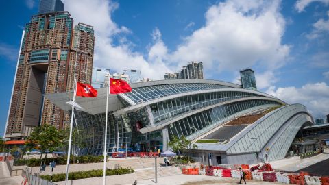 The flags of Hong Kong (L) and China are seen hoisted outside the West Kowloon train station of the High Speed Rail Link to Guangzhou as sales counters were opened to the public for the first time in Hong Kong on September 10, 2018. 
