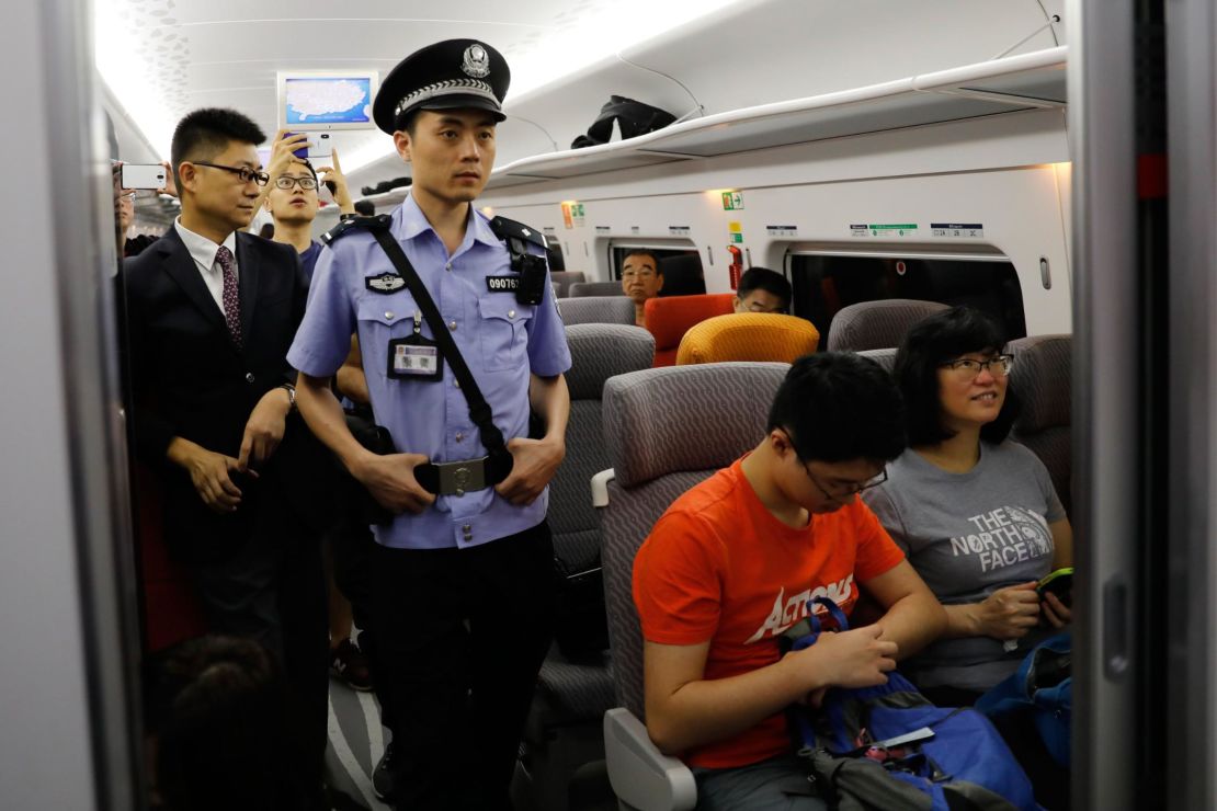 A Chinese police officer patrols a train on the first day of service of the Guangzhou-Shenzhen-Hong Kong Express Rail Link in Hong Kong on September 23, 2018.