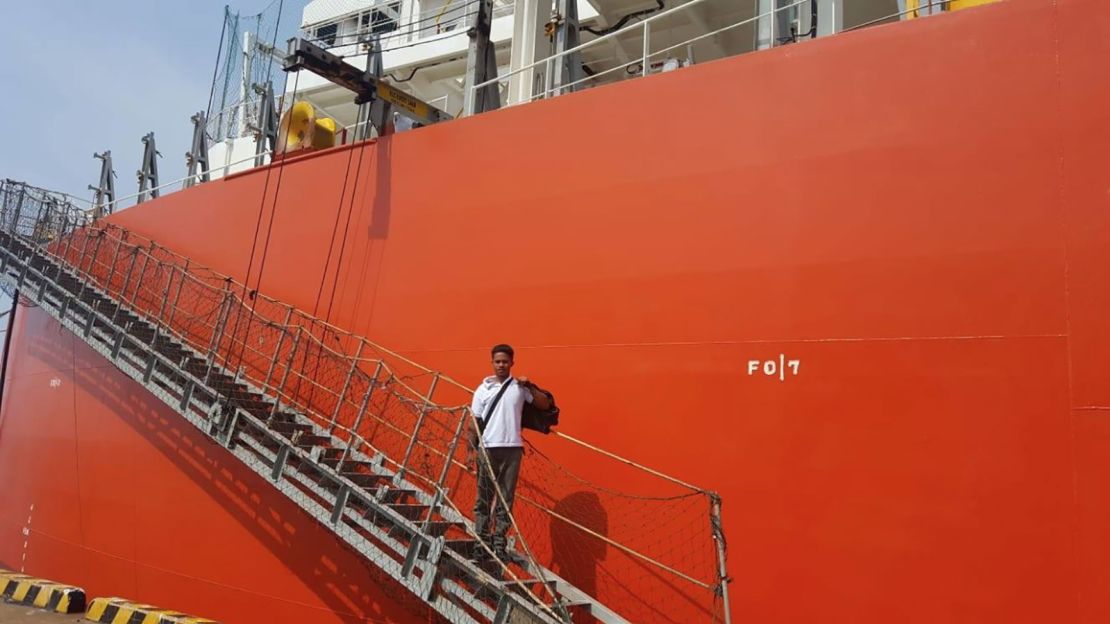 Adilang is seen disembarking from the MV Arpeggio, which plucked him from the sea.