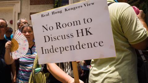 A member of pro-government group 'Real Hong Kong's View' holds a placard that reads "No Room to Discuss HK Independence" during a protest outside the Foreign Correspondents' Club in Hong Kong on August 8, 2018.