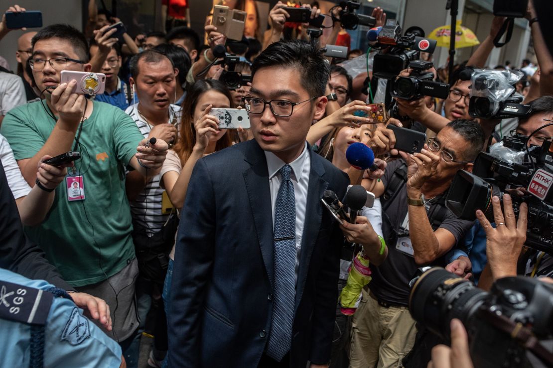 Andy Chan (C), founder of the Hong Kong National Party, is surrounded by members of the media as he leaves the Foreign Correspondents' Club (FCC) in Hong Kong on August 14, 2018.