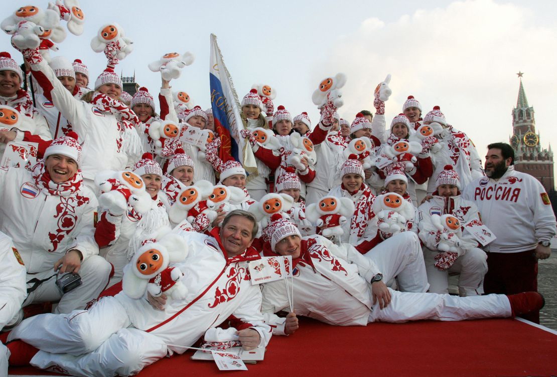 Members of the Russian Winter Olympics team holding Cheburashka.