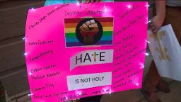 Protest held after priest burns LGBTQ flag outside church in 'exorcism' ceremony