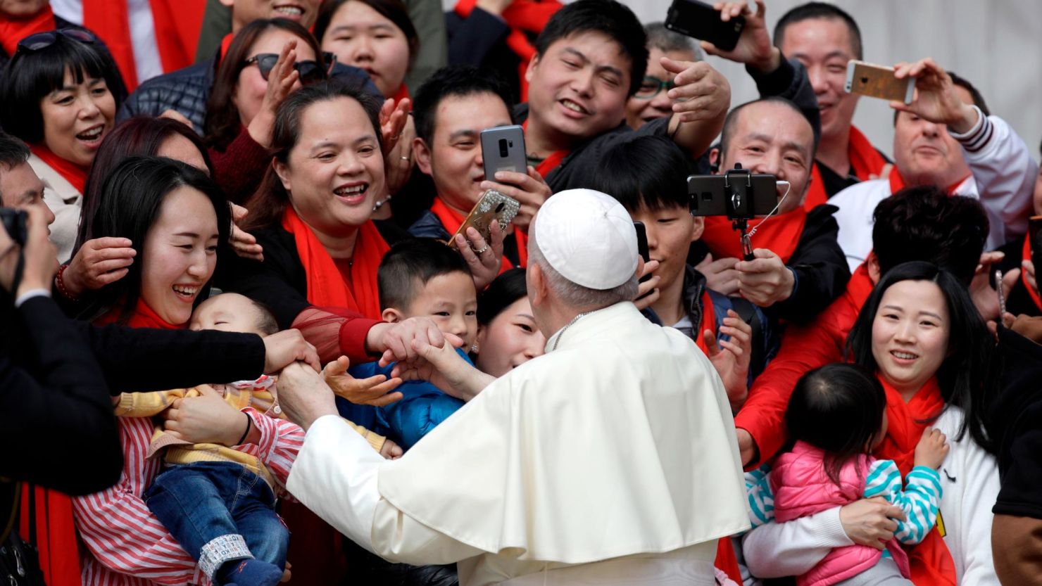 Pope Francis meets a group of faithful from China at the end of his weekly general audience in St. Peter's Square, at the Vatican on April 18.