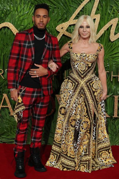 Donatella Versace poses with Formula One driver Lewis Hamilton on the British Fashion Awards red carpet in 2017.