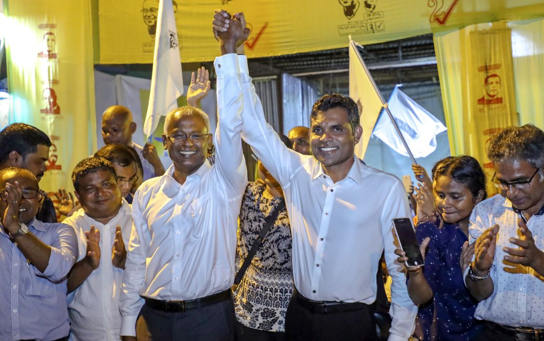 Maldives' opposition presidential candidate Ibrahim Mohamed Solih and running mate Faisal Naseem celebrate their presumed victory in the presidential election.