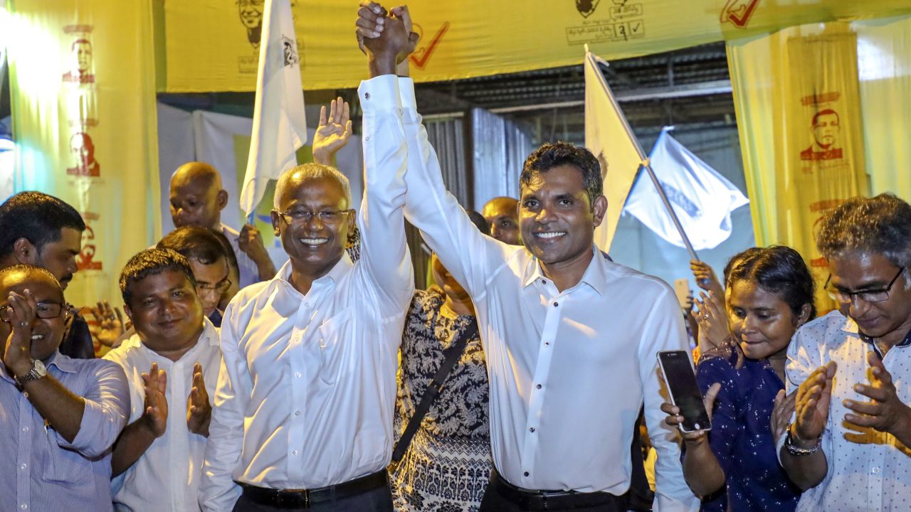 Maldives' opposition presidential candidate Ibrahim Mohamed Solih and running mate Faisal Naseem celebrate their presumed victory in the presidential election.