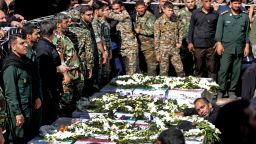 Iranian military members mourn over the bodies during a public funeral ceremony for those killed during an attack on a military parade on the weekend, in the southwestern Iranian city of Ahvaz on September 24, 2018. - Four militants attacked a Saturday parade marking the start of the 1980-1988 Iran-Iraq war, spraying the crowd with gunfire and killing 24 people. (Photo by ATTA KENARE / AFP)        (Photo credit should read ATTA KENARE/AFP/Getty Images)