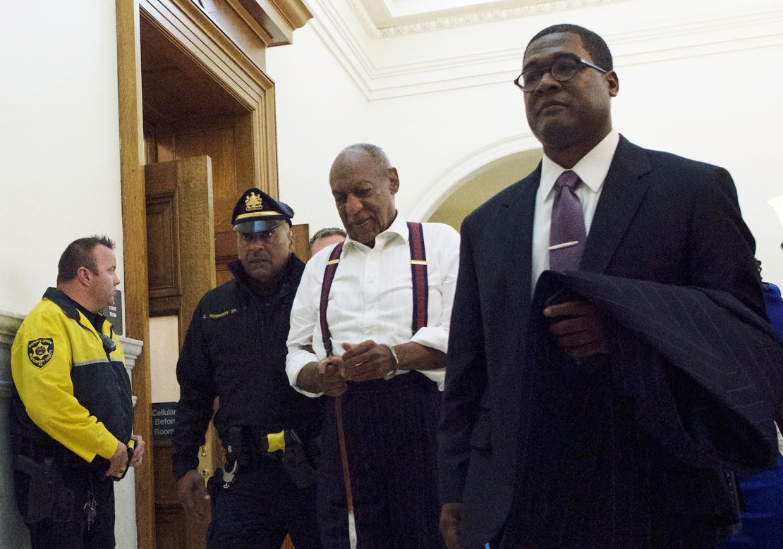 Bill Cosby, center, leaves the courtroom after he was sentenced to three-to 10-years Tuesday for felony sexual assault. 