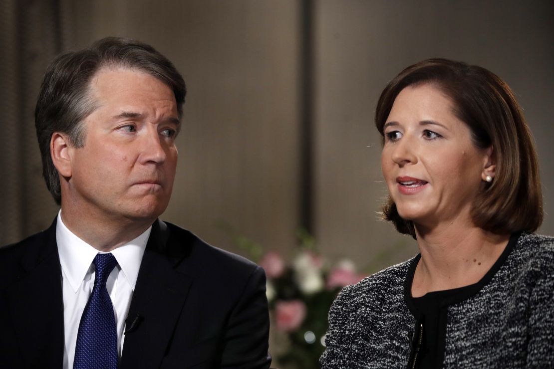 Brett Kavanaugh, left, looks at his wife Ashley Estes Kavanaugh as they answer questions during a Fox News interview.