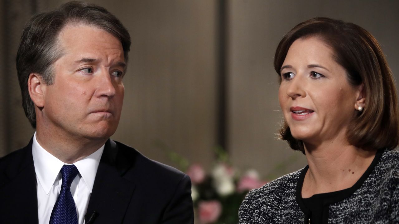 Brett Kavanaugh, left, looks at his wife Ashley Estes Kavanaugh as they answer questions during a Fox News interview.