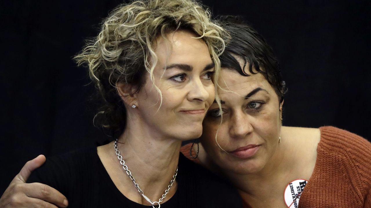 Stacey Pinkerton, left, and Chelan Lasha embrace during a news conference Tuesday.