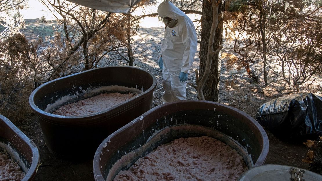 A Mexican Army expert stands near containers with crystal meth paste at a clandestine laboratory in Mexico's Baja California state. "Superlabs" like this one can produce hundreds of pounds of crystal meth daily.