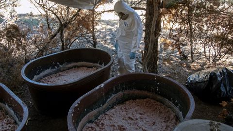 A Mexican Army expert stands near containers with crystal meth paste at a clandestine laboratory in Mexico's Baja California state. "Superlabs" like this one can produce hundreds of pounds of crystal meth daily. 