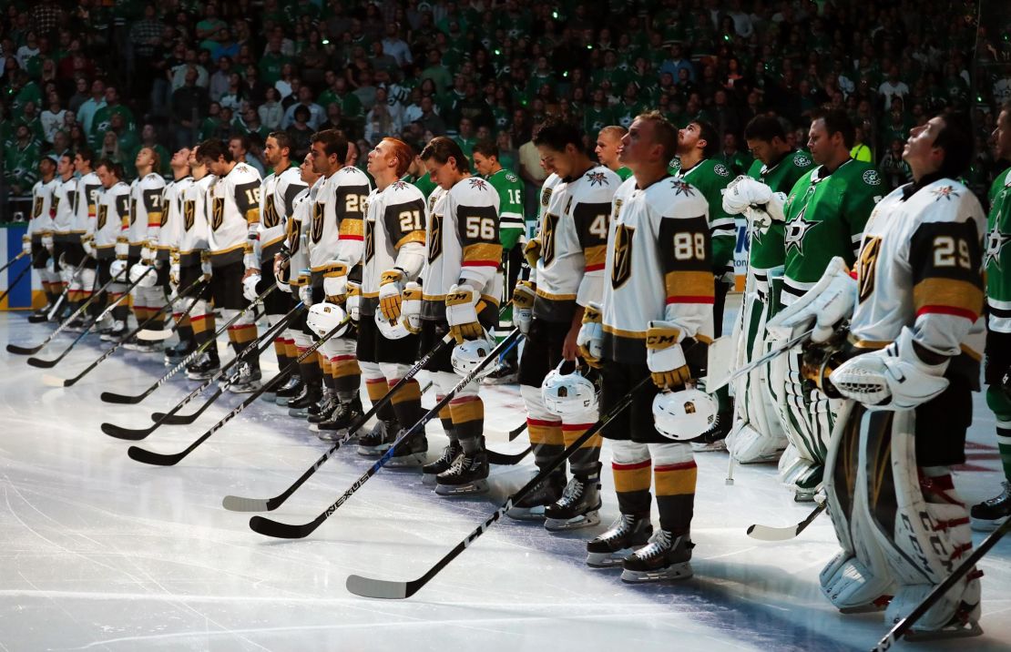 The Vegas Golden Knights and the Dallas Stars stand at attention during the national anthem.