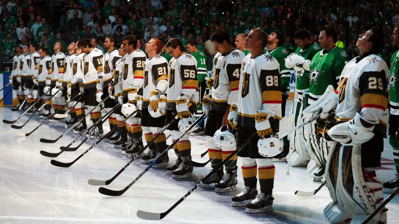 The Dallas Stars stand behind the Vegas Golden Knights on the ice during the National Anthem at American Airlines Center on October 6, 2017 in Dallas, Texas.